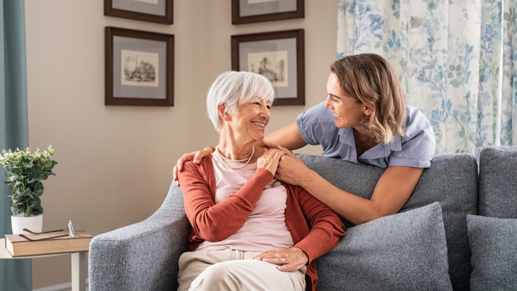 A woman in a couch in conversation with another woman