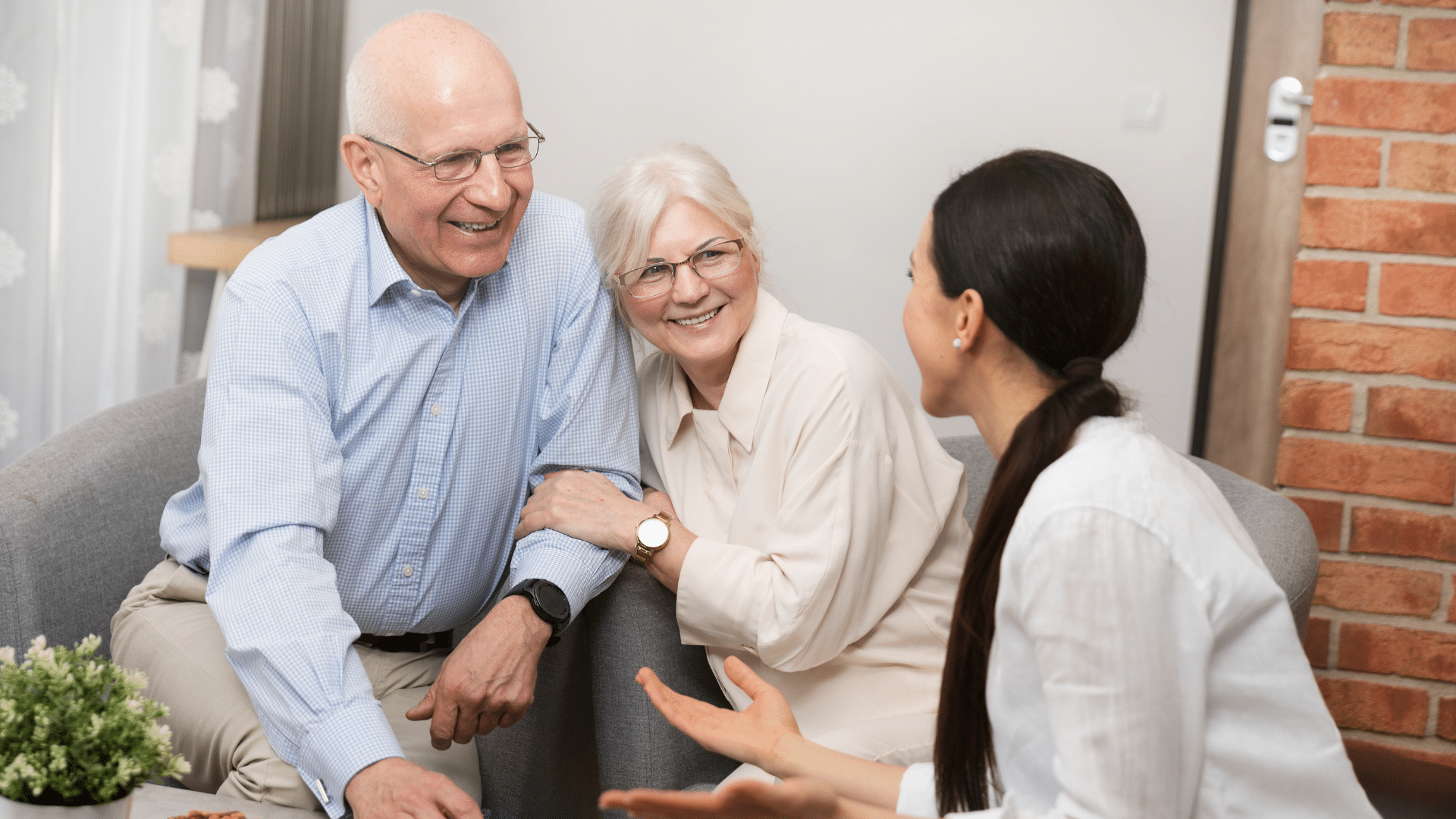 A woman engages in conversation with an elderly couple