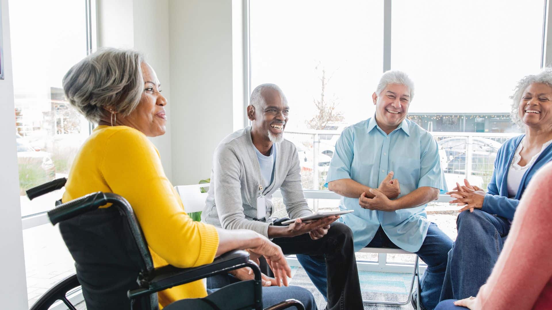 A group of elderly people sitting and chatting together