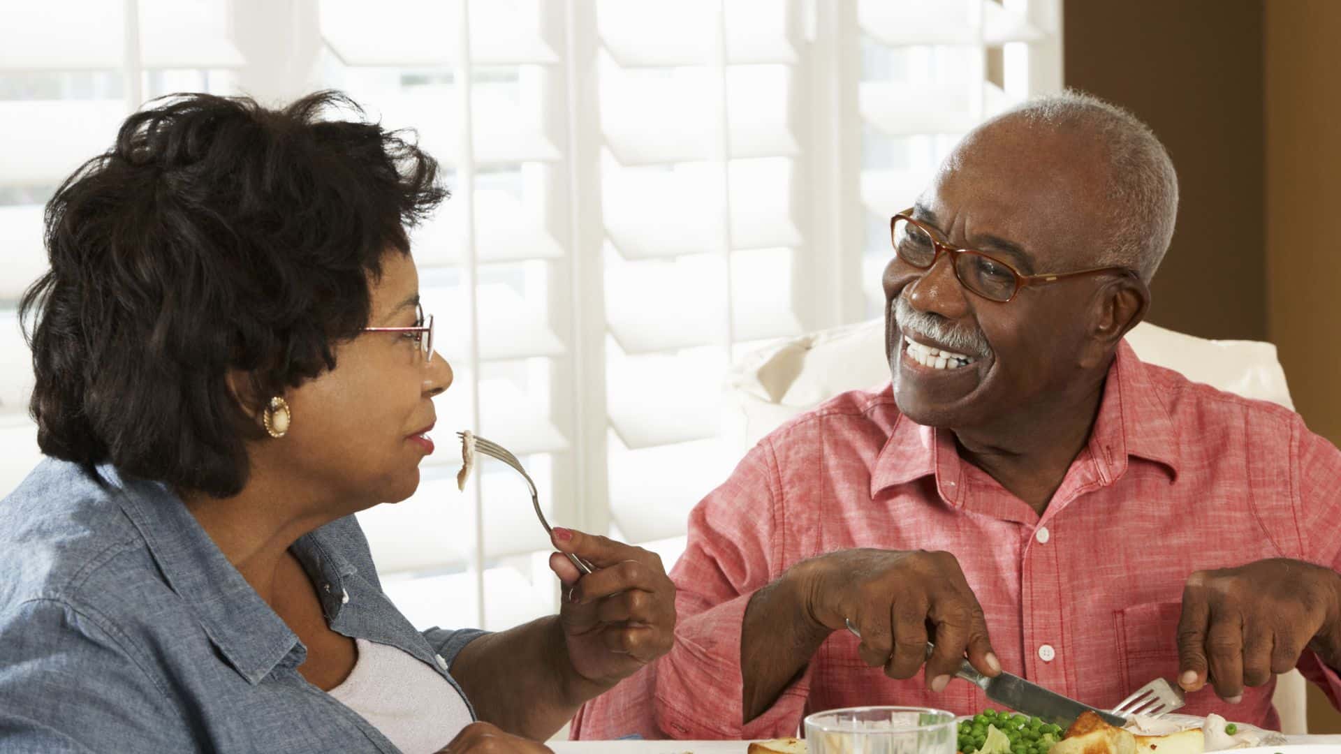 elderly couple enjoying food together